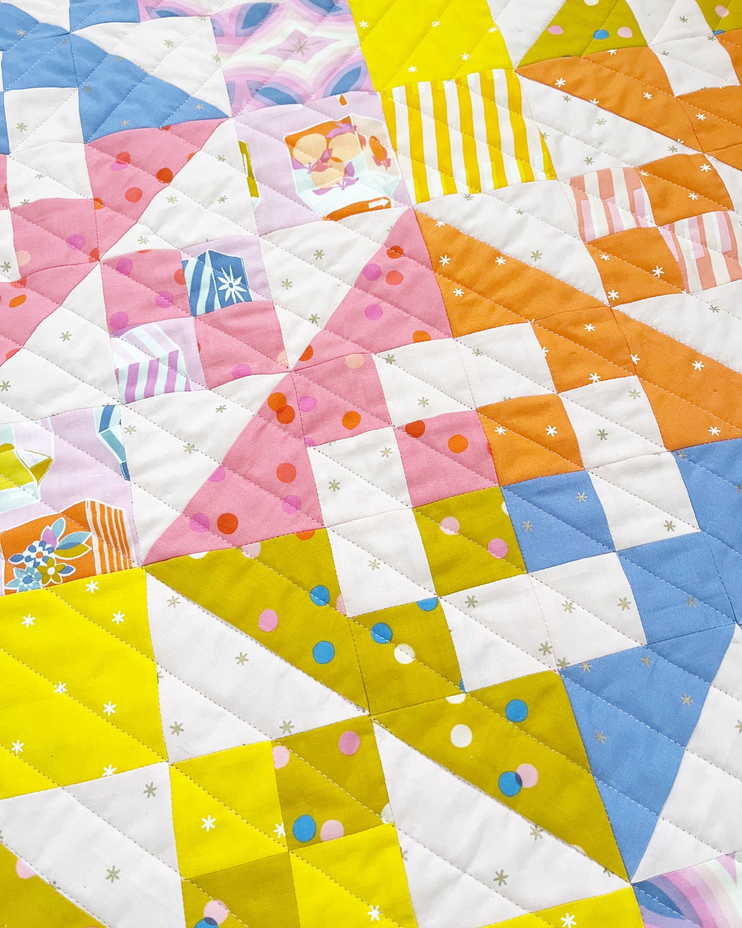 Colorful quilt with patchwork design featuring various shapes and patterns.